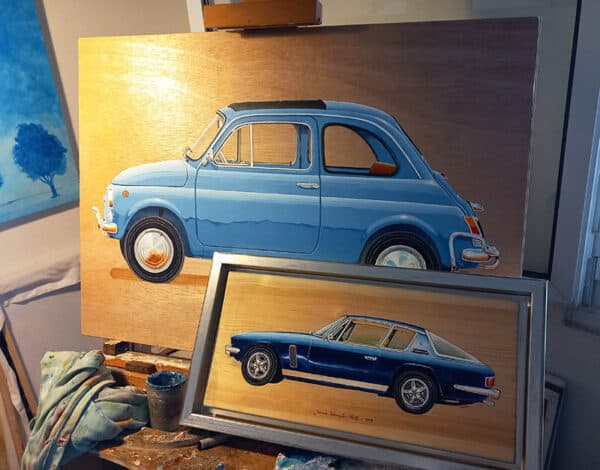 Automotive art: Studio photo with two car paintings on an easel